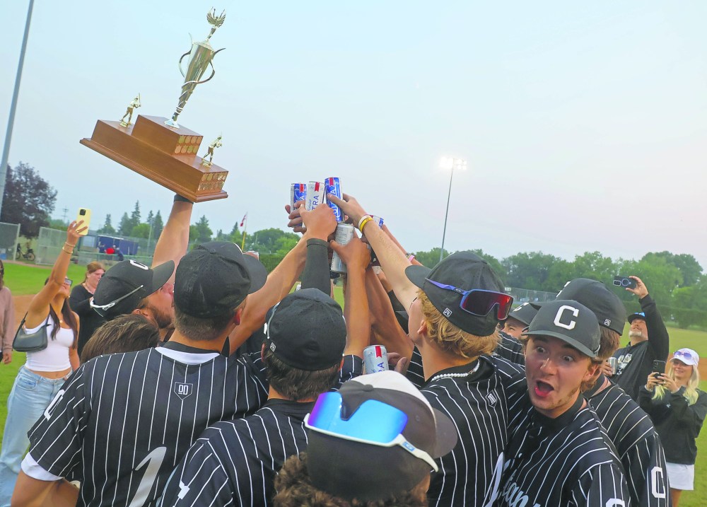 The Carillon Sultans MJBL team celebrates their second consecutive championship with a team toast. (Cassidy Dankochik The Carillon)