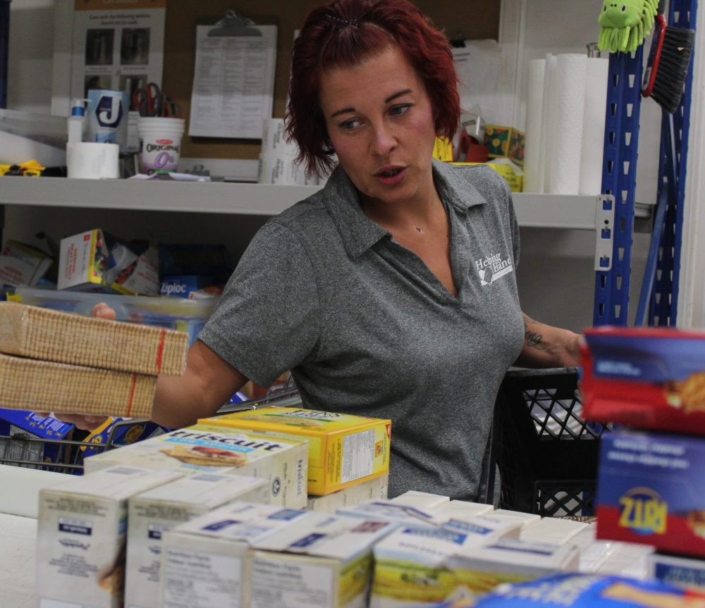 MATTHEW FRANK THE CARILLON
South East Helping Hands staffer Nancy Harder sorts through donated food before its bagged.