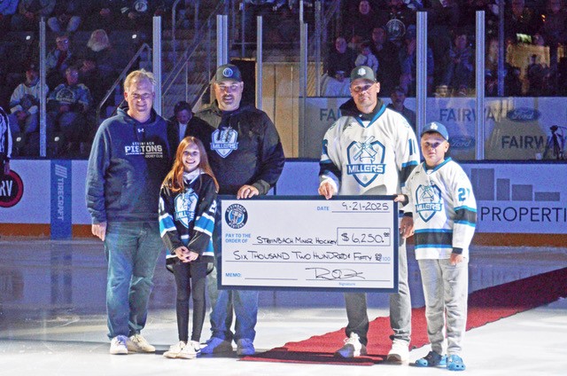 Kent Ledingham (Pistons Board of Directors) presents a cheque to Everly Canada, Ryan Canada, Scott Reimer, and Gavin Reimer from Steinbach Minor Hockey. The Pistons are donating a portion of their 50/50 proceeds inside the Southeast Event Centre to minor hockey as part of a new partnership that includes coaching and complimentary tickets on tournament weekends. (Steinbach Pistons)