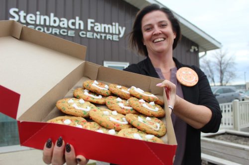 MATTHEW FRANK THE CARILLON 

Steinbach Family Resource Centre executive director Jo-Anne Dalton holds a box of Tim Hortons Smile Cookies. Tim Hortons and the non-profit are partnering for the first time for the Smile Cookie campaign. When a customer purchases the specialty cookie, $1 will go directly to the Steinbach Family Resource Centre. The campaign runs until Nov. 23.