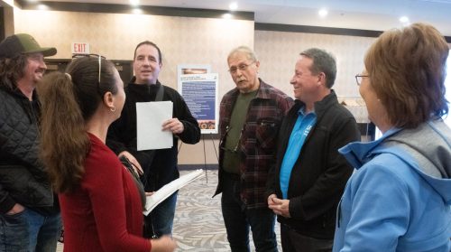 SVJETLANA MLINAREVIC THE CARILLON
RM of Springfield Couns. Andy Kuczynski and Mark Miller (center) speak to residents about their thoughts on the proposed changes Sio Silica made in its application to the province during the company's open house in Winnipeg on Nov. 24, 2025. The councillors are against the mining project.