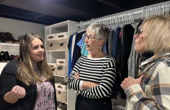 GREG VANDERMEULEN THE CARILLON 

Agape House executive director Tracy Whitby chats with Chrysalis Fund members Karen Toews and Debbie Krahn in the new community closet.