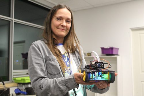 MATTHEW FRANK THE CARILLON 

École Héritage Immersion teacher Darienne Côte holds a student-made robot at the school’s open house on Nov. 13. She said the renovated space allows the robotics program to have its own classroom for the first time.