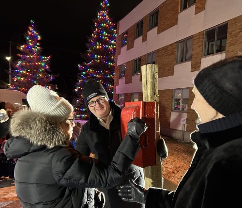 GREG VANDERMEULEN THE CARILLON 

The trees near Bethesda Regional Health Centre light up as Linda Penner flips the switch while Bethesda Foundation board chair Chris Goertzen and fellow honourary tree lighter Judy Penner look on.