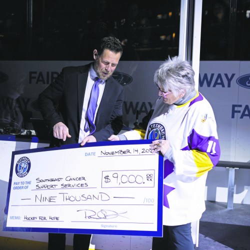 Steinbach Pistons head coach and general manager Paul Dyck presents a cheque with the proceeds from the team's annual jersey auction to Southeast Cancer Support Services executive director Cindi Rempel Patrick. The team raised $4,500 through the auction, with the board of directors matching to reach the $9,000 mark. (Patrick Friesen Steinbach Pistons)