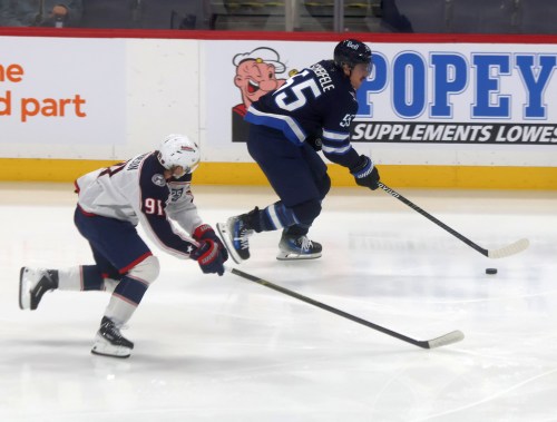 Mark Scheifele carries the puck up the ice during a game in November. (Cassidy Dankochik The Carillon)