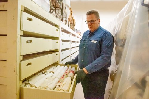 SVJETLANA MLINAREVIC CARILLON ARCHIVES 

Mennonite Heritage Village former assistant curator Garth Doerksen, shown here displaying antique linens that are part of the museum’s collection, was promoted to senior curator recently. The Blumenort native held his previous post for two years and was accepted for the role of senior curator after previous senior curator Andrea Klassen left last year to focus on her family.