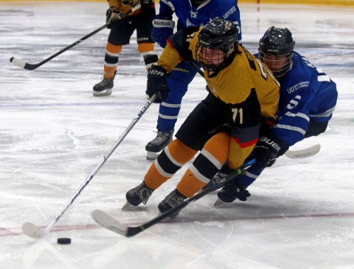 Baylen Dilk shakes off an attempted check from a Steinbach Huskies player. (Cassidy Dankochik The Carillon)