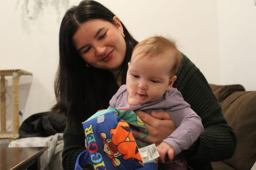 MATTHEW FRANK THE CARILLON 

Dakota Johnston holds her four-month-old daughter Raelynn in their Niverville home. Johnston signed up for roughly 30 daycare wait lists across southeastern Manitoba because there wasn’t space in Niverville’s only child care centre.
