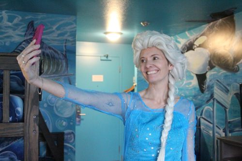 MATTHEW FRANK THE CARILLON 

Cass Wieler, dressed as the Days Inn Elsa, films an Instagram video to showcase one of the hotel’s themed rooms. Wieler went viral, racking up millions of views, after she posted her first video in the costume.