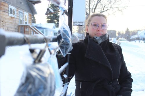 MATTHEW FRANK THE CARILLON 

Lillis Penner stands beside the Giving Fence near her First Street home in Steinbach on Jan. 21.