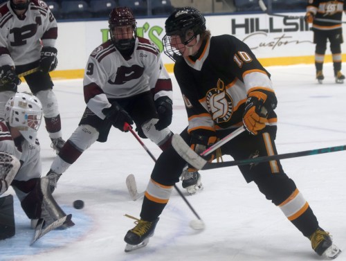 Oliver Campbell gets a shot off by putting his stick between his legs during a Winnipeg High School Hockey League game in Steinbach Feb. 4. (Cassidy Dankochik The Carillon)