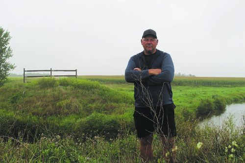 MATTHEW FRANK CARILLON ARCHIVES 

Farmer Arthur Rempel stands by the Manning Canal that divides his corn fields and where the bridge previously was built before it burned in 2019. The canal is seen as one of the major provincial drains that needs remedial work done to it. The province has advised work on the canal will be completed in 2030 or 2031.