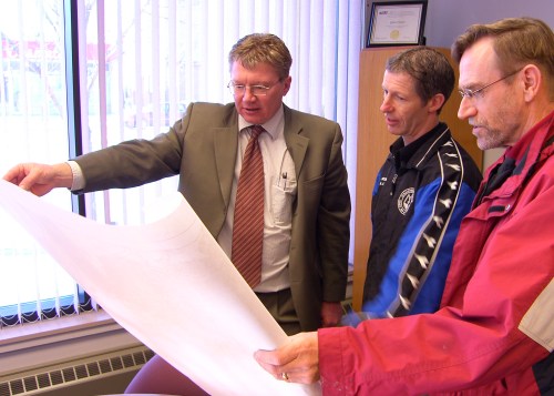 Steinbach Credit Union chief executive officer Glen Friesen, and fund-raising committee members Norm Anderson and Royden Loewen look over plans for the soccer complex.