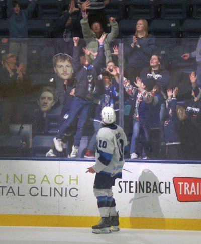 Pistons captain Sam Noad tosses his stick to a crowd of waiting kids after being named a star of the game in Steinbach's 2-0 win over Portage in game five of the MJHL quarterfinals. (Cassidy Dankochik The Carillon)