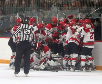 Colton Pakoo is mobbed by teammates after his overtime goal in game six of the CRJHL finals advanced the La Broquerie Habs past St Malo. (Cassidy Dankochik The Carillon)