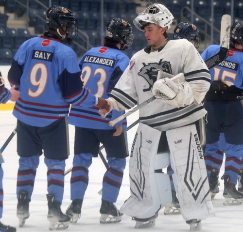 Warren Carter leads the handshake line for the U18 AAA Eastman Selects after their defeat by the Winnipeg Thrashers in the league quarterfinals. (Cassidy Dankochik The Carillon)