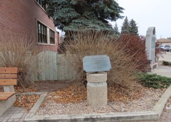 WES KEATING THE CARILLON

Nestled in a corner between the Steinbach post office and the community cenotaph is a pocket park dedicated to the memory of Frank F. Reimer.