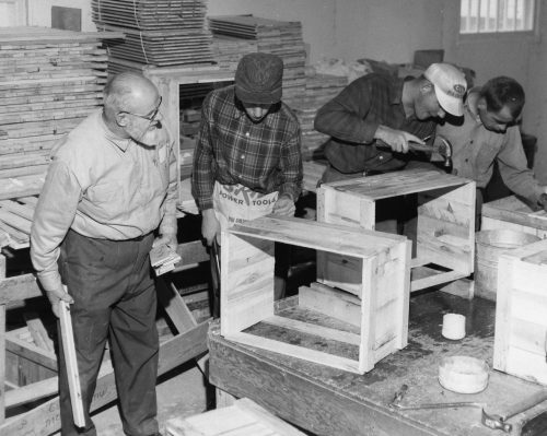 CARILLON ARCHIVES 

John Barkman supervises a group of older boys as they assemble wooden crates at Kindale School in 1966.