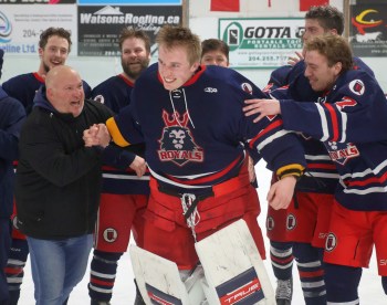 Matthew Thiessen is congratulated by his teammates after he was announced as the SEMHL's most valuable player for the playoffs. (Cassidy Dankochik The Carillon)