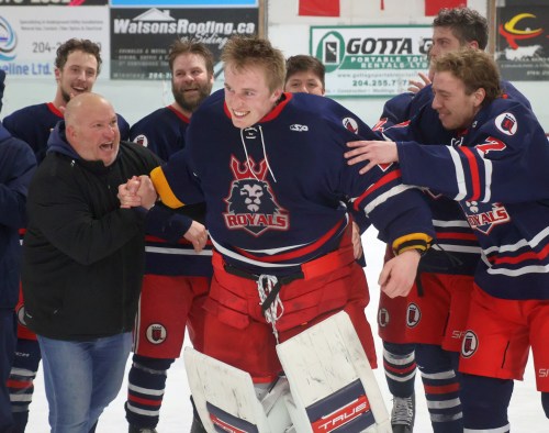 Matthew Thiessen is congratulated by his teammates after he was announced as the SEMHL's most valuable player for the playoffs. (Cassidy Dankochik The Carillon)