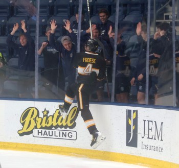 Peyton Froese closed out the SRSS Sabres home schedule in style, scoring the overtime winner in game two of the school's series against Oak Park before celebrating with the watching Steinbach Pistons. (Cassidy Dankochik The Carillon)