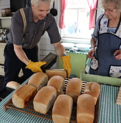 Volunteers baking bread during Fall on the Farm 2025.
