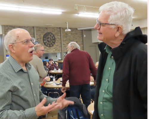 WES KEATING THE CARILLON 

Paul Overby talks shop with Stanley Soil Association technician Richard Warkentin at Regen Day at Friedensfeld.