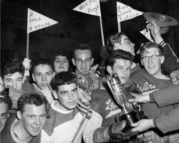 A jubilant crowd of La Broquerie fans wave pennants after the Habs defeated Steinbach for the Carillon Cup in 1956.