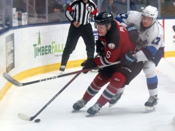 Virden captain Ty Plaisier shields the puck away from Grady Hoffman during MJHL semi-final action in Steinbach. (Cassidy Dankochik The Carillon)