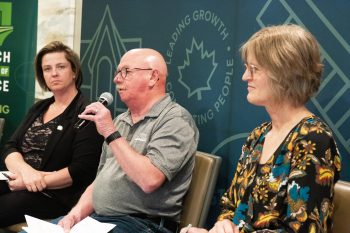 SVJETLANA MLINAREVIC THE CARILLON
Ken Dyck (South East Helping Hands) speaks during a panel discussion at the Steinbach Chamber of Commerce’s Collective Impact: Non-Profits at the Table at Smitty’s in Steinbach on May 14, 2026, while Steinbach Family Resource Centre’s executive director Jo-Anne Dalton and Jeannette DeLong (enVision Community Living listen. The chamber was asked by non-profits in the city to host an event where they could all meet and share their stories, what challenges they are encountering, and how they are building relationships in the community. Twenty-eight non-profits were represented at the luncheon.