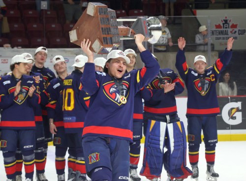 Marlen Edwards lifts the Centennial Cup into the air after helping the Niverville Nighthawks to a national championship. (Cassidy Dankochik The Carillon)