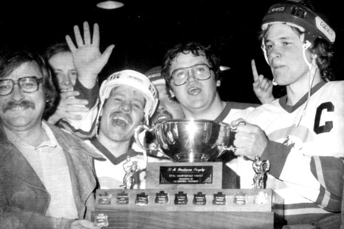 The Niverville Clippers capture the Hanover Tache Hockey League championship trophy for the first time in their history, winning a 9-8 shootout in the sixth game of the 1979-80 finals against Mitchell. Accepting the L.A. Barkman Trophy from league vice president Tony Romanow are Tony Kehler, Clare Braun and Clippers captain Bert Krahn. Braun is now the team president of the MJHL’s Niverville Nighthawks.
