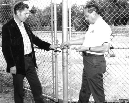 CARILLON ARCHIVES 

George Kosowan and Mel Mehling padlock the gate at the Kinsman Pool to emphasize an earlier club decision to not open the facility for the summer of 1975.