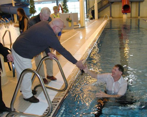 CARILLON ARCHIVES 

Mayor Les Magnusson is helped out of the new Steinbach indoor swimming pool by Dwight Reimer, after a dunking at the official opening of the long awaited facility at A.D. Penner Park.