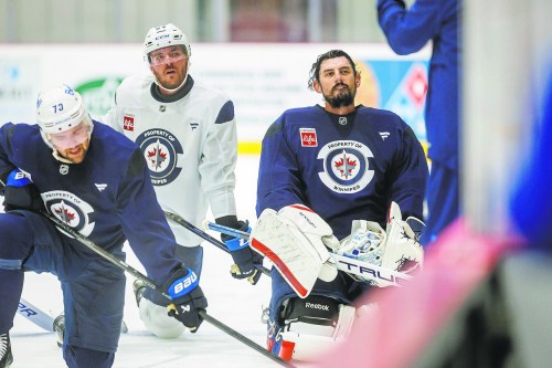 MIKE DEAL / FREE PRESS
Winnipeg Jets’ Ethan Frisch (73), Dylan Samberg (54), and goaltender Connor Hellebuyck (37) during training camp at Hockey For All Centre Thursday.
250918 - Thursday, September 18, 2025.