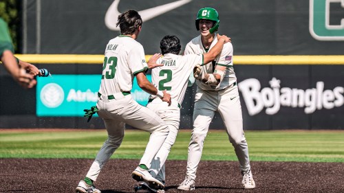 Charlotte 49ers teammates mob Cody Gunderson after the St Malo product's a two-run walk-off single in the final conference game of the year kept the team's season alive. (Madeline Davis/Charlotte Athletics)