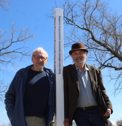 MATTHEW FRANK THE CARILLON 

(From left) Glen Klassen and Ed Krahn, co-chairs of the Eastmenn historical committee stand by the newly unveiled peace pole on March 8 at the Mennonite Heritage Village.