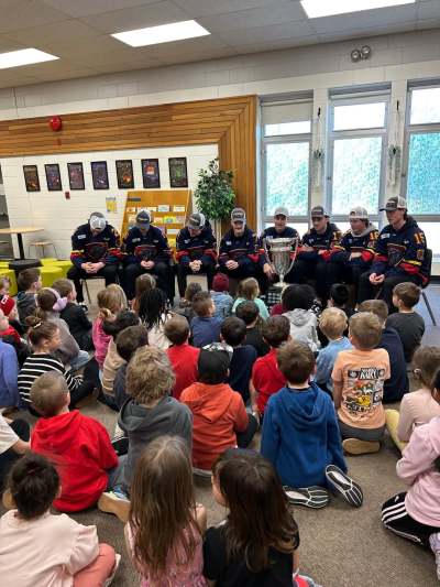 Niverville Nighthawks players present to students at Niverville Elementary School following their Turnbull Cup championship win. (Niverville Nighthawks Facebook)