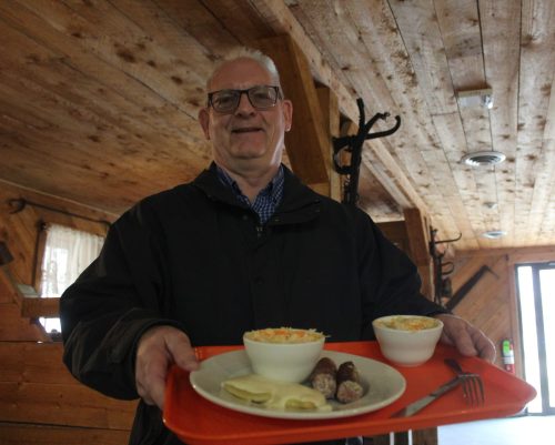 Robert Goertzen, executive director of the Mennonite Heritage Village, holds a perogy and farmer sausage platter inside the Livery Barn Restaurant on May 5. The village opened for the season on May 1. Free admission to the museum grounds will be available on May 9 as part of Manitoba Day celebrations. The Livery Barn Restaurant will host a Mother’s Day buffet meal on May 10. Last year’s meal saw more than 400 people attend.