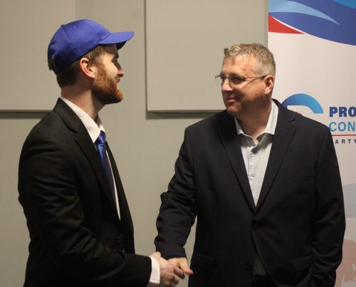 GREG VANDERMEULEN THE CARILLON 

Left, Springfield-Ritchot PC candidate Adam McAllister accepts congratulations from his competitor Craig Tomlinson after the vote.
