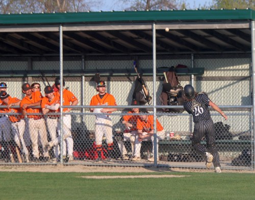 Carillon catcher Dayton Christianson tracks down a foul ball in front of the new-look dugouts at A.D. Penner Park while Winnipeg South players look on May 26. (Cassidy Dankochik The Carillon)
