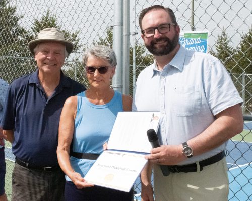 SVJETLANA MLINAREVIC THE CARILLON
Claude and Annette Tetrault (left) receive a provincial certificate of recognition from La Verendrye MLA Konrad Narth at the Marchand pickleball courts that officially opened during the commemoration of the Claude and Annette Tétrault Park on May 30, 2026. The couple donated two acres to the RM of La Broquerie 13 years ago to build a park. The couple also donated $25,000 to build the pickleball courts at the park after Claude suggested the RM build them last year.