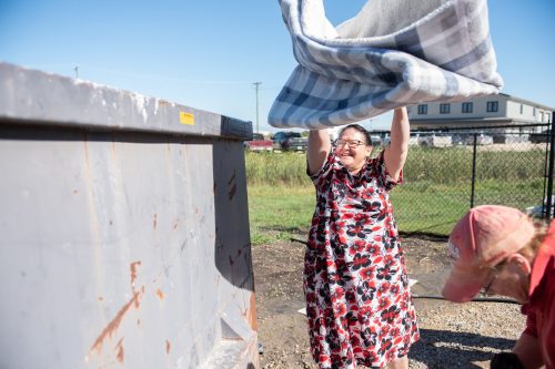 SVJETLANA MLINAREVIC CARILLON ARCHIVES 

Steinbach and Area Animal Rescue Inc. volunteer Tamara Toews throws a blanket into the dumpster as she helped clean up the aftermath of the Sept. 16, 2024, flood to the organization’s basement. SAAR had just opened their new facility less than two months before their basement was flooded. This was the same fate suffered by hundreds of other Steinbach residents.