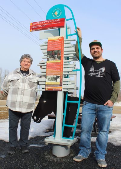 CHRIS GAREAU THE CARILLON ARCHIVES 

The Dawson Trek returns for the second year in a row to raise funds for the Musee Dawson Trail Museum to maintain the 15 wayfinding markers along the Dawson Trail from Winnipeg to Northwest Angle at Lake of the Woods. Pictured is museum president Yvonne Fontaine-Godard (left) and trek founder Kyle Waczko at the Dawson Trail marker in Richer. Money raised by cyclists in the first Dawson Trek totalled almost $10,000.