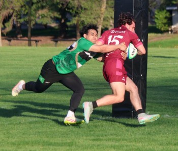 A Wanderers player tries in vain to stop an Eastman player from touching the ball down for a try during a match at A.D. Penner Park May 28. The teams were forced to play with just 10-per-side because of a lack of players for the home team. (Cassidy Dankochik The Carillon)