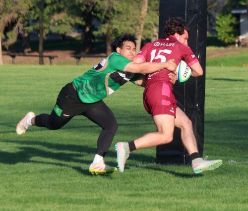 A Wanderers player tries in vain to stop an Eastman player from touching the ball down for a try during a match at A.D. Penner Park May 28. The teams were forced to play with just 10-per-side because of a lack of players for the home team. (Cassidy Dankochik The Carillon)