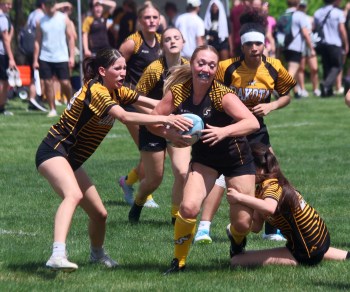 A Steinbach Regional rugby player breaks a pair of Dakota would-be tackles en route to a try during the finals of the SRSS rugby sevens tournament May 29. SRSS would win the girls division, with St Paul's dominating the boys side. (Cassidy Dankochik The Carillon)