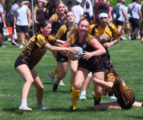 A Steinbach Regional rugby player breaks a pair of Dakota would-be tackles en route to a try during the finals of the SRSS rugby sevens tournament May 29. SRSS would win the girls division, with St Paul's dominating the boys side. (Cassidy Dankochik The Carillon)