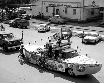 August 2, 1963 
CARILLON ARCHIVES 

The roof of Derksen Printers at 377 Main Street provided a perfect perch for Bruno Derksen to take overhead pictures of the 1963 Hanover Fair Parade. An added bonus for The Carillon News advertising salesman was that one of his loyal customers was sure to have his feed mill featured along with the colourful floats.